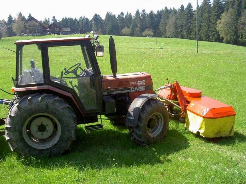 Tractor with mower deck for field and pasture mowing