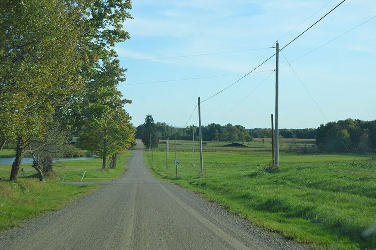 Bulk material delivered and spread along a rural drive